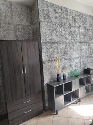 a living room with a brick wall and a wooden cabinet at Page55 in Piraeus