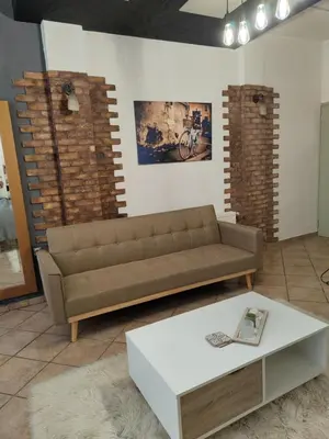 a living room with a couch and a coffee table at Page55 in Piraeus