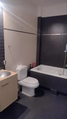 a bathroom with a toilet and a sink and a bath tub at ΒΙΛΑ ΜΕ ΠΙΣΙΝΑ ΣΤΗΝ ΠΑΙΑΝΙΑ in Paianía