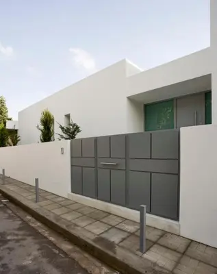 a white house with a white wall at ΒΙΛΑ ΜΕ ΠΙΣΙΝΑ ΣΤΗΝ ΠΑΙΑΝΙΑ in Paianía
