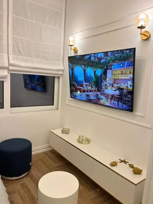 a living room with a tv on a wall at White House Vouliagmeni 3-Free Parking ,Near the Sea in Athens
