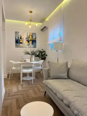 a living room with a couch and a table at White House Vouliagmeni 3-Free Parking ,Near the Sea in Athens