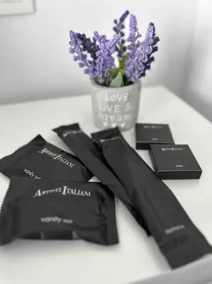 a vase of purple flowers sitting next to black cards at Cozy apartment in a new building apartment 2 in Piraeus