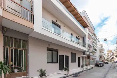 an apartment building with a balcony on a street at Cozy apartment in a new building apartment 2 in Piraeus