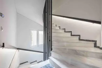 a staircase in a house with white walls at Cozy apartment in a new building apartment 2 in Piraeus