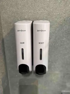 two white wii controllers sitting next to each other at Cozy apartment in a new building apartment 3 in Piraeus
