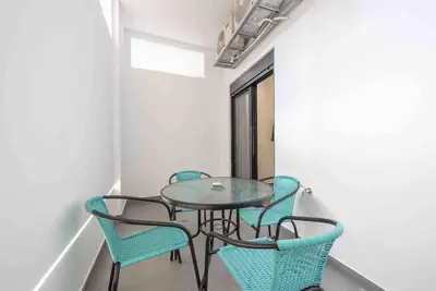a glass table and chairs in a room at Cozy apartment in a new building apartment 4 in Piraeus