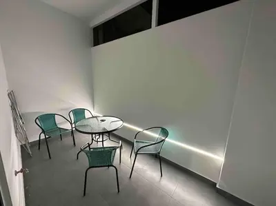 a group of chairs and a table in a room at Cozy apartment in a new building apartment 4 in Piraeus