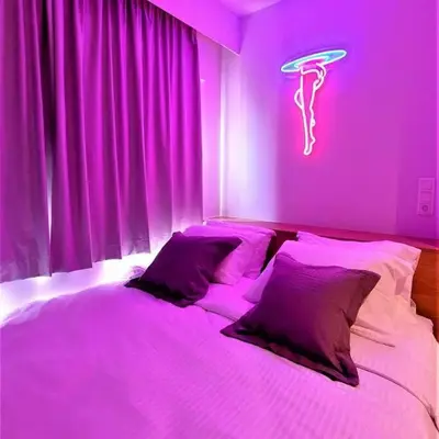 a bedroom with a bed with a purple light at BlueMotion - CruiseNest 143 5B in Piraeus