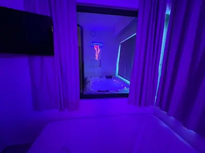 a purple room with a tub and a mirror at BlueMotion - CruiseNest 143 5B in Piraeus