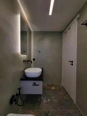 a bathroom with a white sink and a white door at BlueMotion - CruiseNest 143 5B in Piraeus