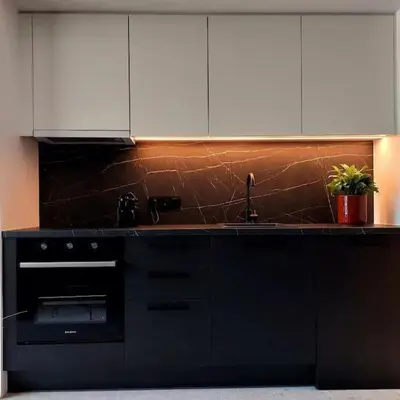 a black kitchen with white cabinets and a sink at BlueMotion - CruiseNest 143 5B in Piraeus