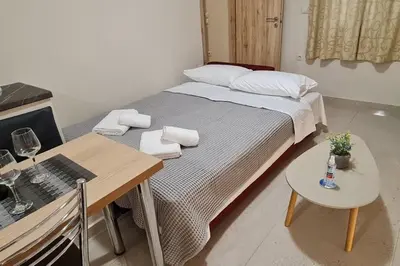 a small bedroom with a bed and a table at M&S Apartments Athens in Athens