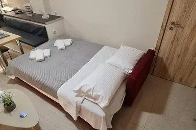 a bedroom with a large bed with white sheets and pillows at M&S Apartments Athens in Athens