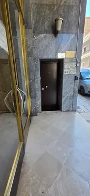 a door in a building with a parking lot at M&S Apartments Athens in Athens