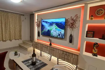 a living room with a television on a wall at M&S Apartments Athens in Athens