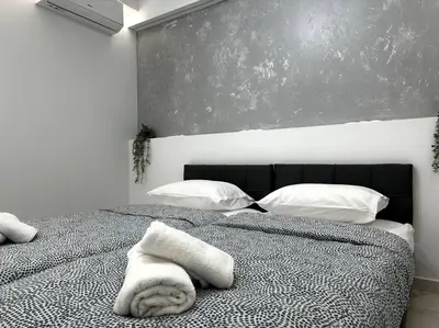 a bedroom with a bed with white towels on it at Cozy Elegant Residence #1 VIPGreece in Athens
