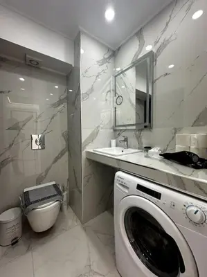 a bathroom with a washing machine and a sink at Cozy Elegant Residence #1 VIPGreece in Athens