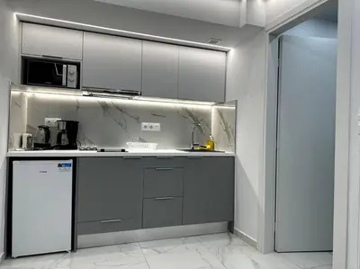 a kitchen with white cabinets and a refrigerator at Cozy Elegant Residence #1 VIPGreece in Athens