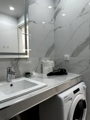 a bathroom with a sink and a washing machine at Cozy Elegant Residence #1 VIPGreece in Athens