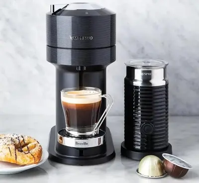 a coffee maker with a cup of coffee and a pastry at LuxSuite by Voula & Glyfada beach in Athens