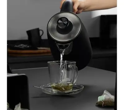 a person is pouring coffee into a glass at LuxSuite by Voula & Glyfada beach in Athens