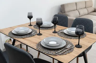 a wooden table with plates and wine glasses on it at Drapetsona Modern Living (DRAP_C2) in Piraeus