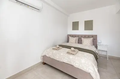 a bedroom with a bed with two towels on it at Drapetsona Modern Living (DRAP_C2) in Piraeus