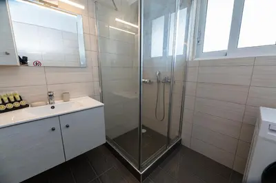 a bathroom with a shower and a sink at Drapetsona Modern Living (DRAP_C2) in Piraeus