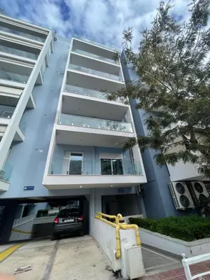 an apartment building with a car parked in front at Drapetsona Modern Living (DRAP_C2) in Piraeus