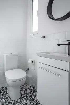 a white bathroom with a toilet and a sink at Voula Panoramic Terraces - Greecing in Athens