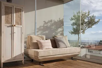 a couch in a room with a large window at Glyfada Panoramic Penthouse in Athens