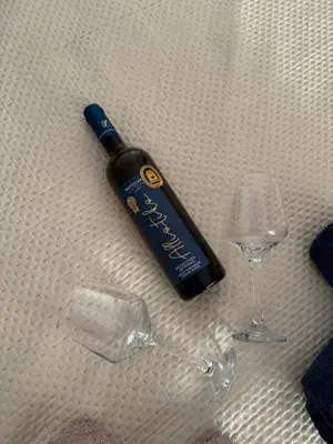 a bottle of wine and a glass on a table at Sunshine Bliss Apartment in Athens