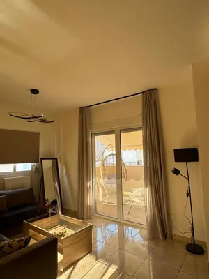a living room with a couch and a sliding glass door at Sunshine Bliss Apartment in Athens
