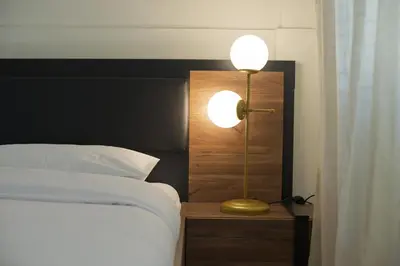 a bedroom with a bed with a lamp next to it at Milena Comfy Piraeus Reno Apt AC & Full Kitchen in Piraeus