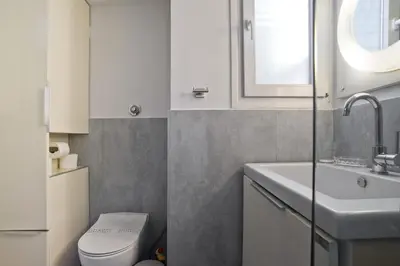 a small bathroom with a toilet and a sink at Milena Comfy Piraeus Reno Apt AC & Full Kitchen in Piraeus