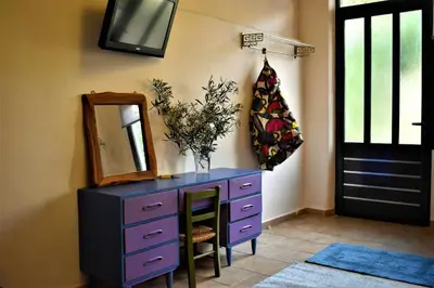 a purple dresser with a mirror and a mirror at Egaleo Relax Apartment in Athens