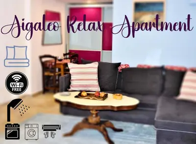 a living room with a couch and a table with food on it at Egaleo Relax Apartment in Athens