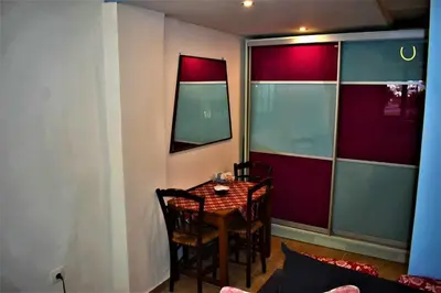 a dining room with a table and chairs in a room at Egaleo Relax Apartment in Athens