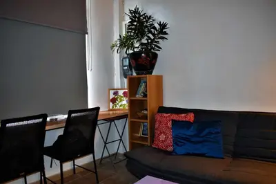 a living room with a couch and a table and chairs at Egaleo Relax Apartment in Athens