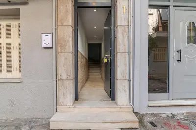 a hallway of a building with a door and stairs at Warm and modern brand new apartment in Piraeus