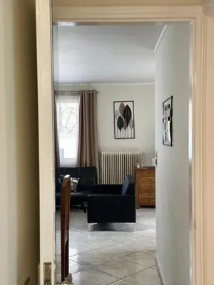 a living room with a couch and a table at Peaceful Cottage Porto Rafti in Porto Rafti