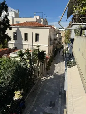 an empty street in a city with buildings at Plaka K15 in Athens
