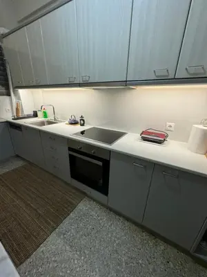 a kitchen with white cabinets and a sink at Plaka K15 in Athens
