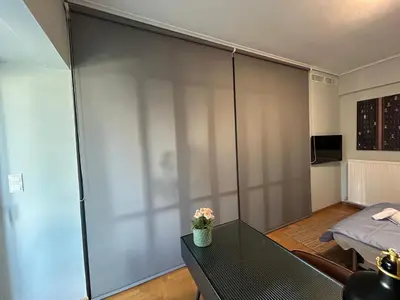 a large sliding door in a living room with a table at Plaka K15 in Athens