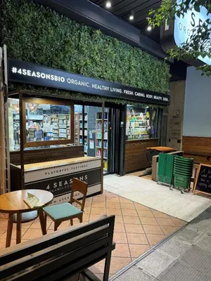 a store front with a table and a bench at Plaka K15 in Athens