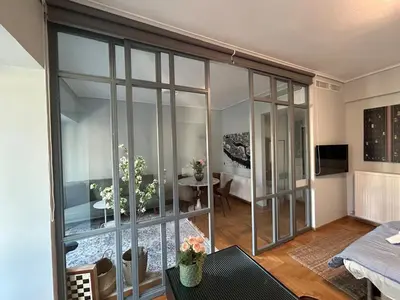 a living room with a large glass wall at Plaka K15 in Athens