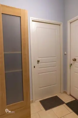 a hallway with a white door and a mirror at Aphrodite - Cozy & Bright Studio in Egaleo-Athens in Athens