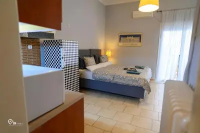 a small room with a bed and a kitchen at Aphrodite - Cozy & Bright Studio in Egaleo-Athens in Athens