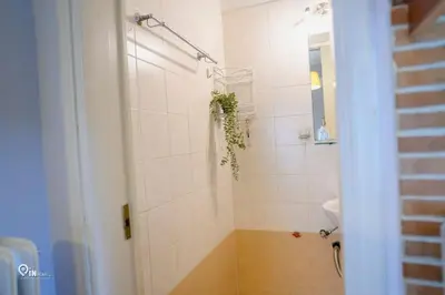 a bathroom with a shower with a toilet and a sink at Aphrodite - Cozy & Bright Studio in Egaleo-Athens in Athens